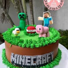 a cake that is decorated to look like minecraft with animals and farm animals on top