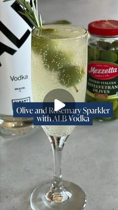 an olive and rosemary spritker cocktail with alb vodka in the foreground