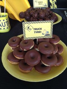 a table topped with lots of donuts covered in chocolate