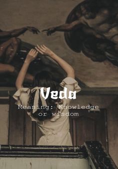 a woman standing in front of a painting with the words veda meaning knowledge or wisdom