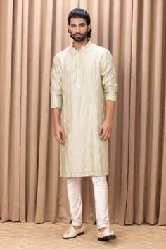 Mint green kurta with embroidered floral motifs. Comes with an ivory churidar.
Component: 2
Pattern: Embroidered
Type Of Work: Floral Patterns
Neckline: Mandarin Collar
Sleeve Type: Straight Long
Fabric: Cotton and Silk, Lining: Cotton
Color: Green
Other Details: 
Front concealed button placket
Note: Pant worn by the model is not for sale
Occasion: Wedding - Aza Fashions Modern Groom, Kurta Set For Men, Couture Outfits, Straight Kurta, Mens Luxury Fashion, Sherwani, Churidar, Kurta Set, Floral Motifs