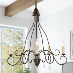 a chandelier hanging from the ceiling in a dining room