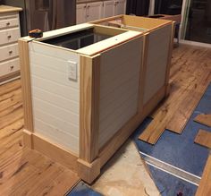 an unfinished kitchen with wooden floors and cabinets