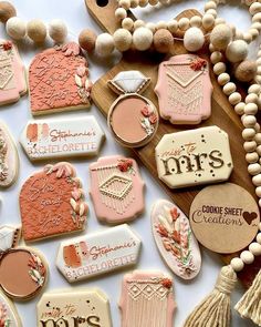 some cookies are laying on a table and decorated with different types of icing decorations