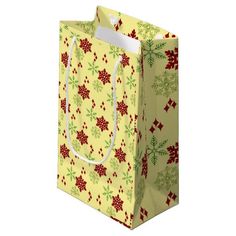 a yellow shopping bag with red and green snowflakes on it's side