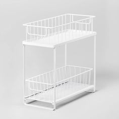 two white wire baskets sitting on top of each other