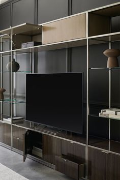 a large flat screen tv sitting on top of a wooden entertainment center