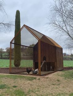 a chicken coop in the middle of a field