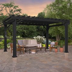 an outdoor seating area with couches, tables and potted plants on the patio