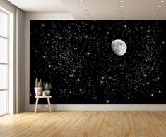 an empty room with a black wall and stars in the night sky, as well as a full moon