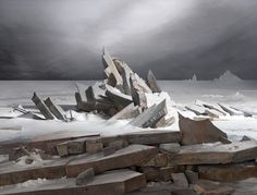 a pile of rocks sitting on top of snow covered ground