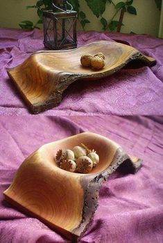 two wooden bowls with nuts in them on a purple cloth