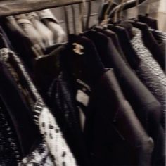 black and white photograph of clothes hanging on rail