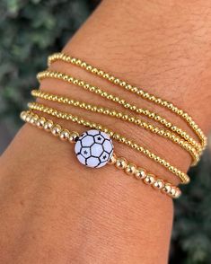 Our beaded bracelets are the perfect combination of fun and class.  After all, life is too short to be boring!  Add our Soccer Ball Bracelet to your collection.  They make a perfect gift for your captain or teammates! Features: -elastic stretch band -18K Gold plated brass beads(4mm) -6 inches around  -tennis ball Ball Bracelet