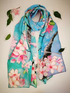 Hand painted luxury silk shawl scarf with Pink Cherry Blossom branches in sky blue/ aquamarine green background. Very fresh and pure look. The scarf is painted on Crepe de Chine silk. Crepe de Chine has slightly crinkled texture with a gentle, graceful drape and delicate touch. This fabric is one of the most luxurious silks. It is quite thick and can warm in cool weather. This design Scarf is MADE TO ORDER and available in 2 sizes: 80x35inches (205x90cm)- Extra Large. This size scarf is SHOWN on Blue Silk Scarf For Beach In Spring, Blue Bohemian Silk Scarf For Spring, Bohemian Blue Silk Scarf For Spring, Artistic Blue Silk Scarf For Spring, Spring Blue Floral Print Silk Scarf, Hand Painted Tree, Pareo Sarong, Cherry Blossom Branch, Pink Scarf