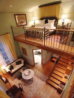 an aerial view of a bedroom and living room from the top floor to the second floor