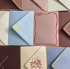 many different colored envelopes with writing on them