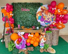 an outdoor birthday party with balloons, decorations and decorating on the table for children's birthday