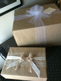 two wrapped presents sitting on top of a table