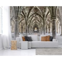 an image of a living room setting with large arches and stone flooring in the background