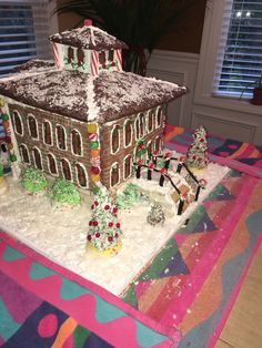 a large gingerbread house on top of a table