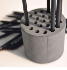 several black pencils are sitting in a holder