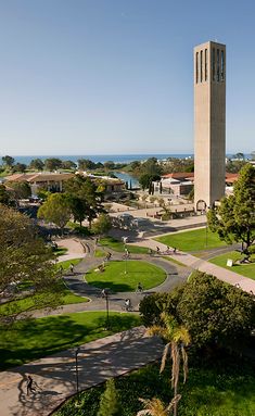 an aerial view of a clock tower in the middle of a park