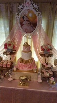 a table topped with lots of cakes and cupcakes