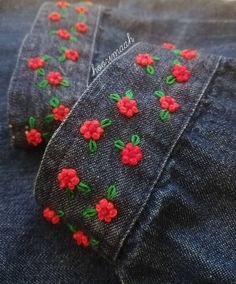 two pairs of jeans with red flowers on them