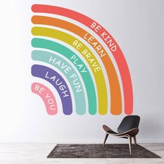 a rainbow wall decal with the words be kind to learn, be brave, have fun, laugh and be joy