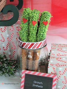 there is a potted cactus with candy in it and some cards on the table