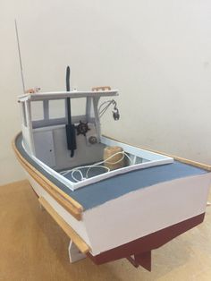 a model boat sitting on top of a wooden table