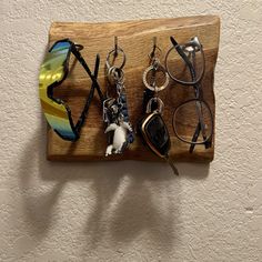 This is a handmade entryway organizer to house your keys and sunglasses.  It has 2 hooks and 2 eyeholes to hang your items.  It is made with a finely finished piece of live-edge oak from the backwoods of Oklahoma.  The piece measures 9 inches by 8 inches and is 1 inch thick.  If rustic is your thing, this piece would look great by the back door. Has two sawtooth hangers in the back or a string for single nail hanging. Proudly handmade in the U.S.A. Thanks for supporting my small business. Entryway Organizer, Sunglasses Holder, Sunglass Holder, Back Door, Live Edge, Hangers, Oklahoma, Halloween Shopping, 1 Inch