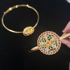 'Bajuband' or Armlet is a type of bracelet worn on the upper part of the arm. Armlets create a style statement for women in present times. Besides being wedding jewelry, armlets are also fashion jewelry. Armlets are the aptest accessory for weddings, engagements, theme parties, and religious occasions. Dainty armlets look beautiful when worn with lehengas, saris, or any sleeveless traditional attire. Stonework design (W x H): 1 X 1 inches. Material: Antique gold alloy Stones: Cubic Zirconia, Sem Heavy Multicolor Temple Jewelry Bracelets, Ceremonial Temple Style Gold Bracelet For Festivals, Festive Hand-set Gold Bracelet In Temple Jewelry Style, Multicolor Intricate Temple Jewelry Bangle, Formal Multi-stone Gemstone Bangle, Gold Alloys, Indian Wedding Jewelry, Theme Parties, Uncut Diamond