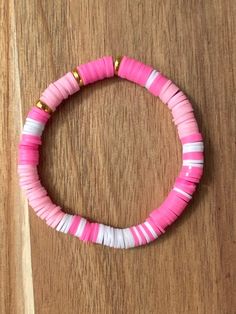 Clay bead bracelet Approximately 6.5 inches long  Elastic band.  My shop has other designs as well!! Please visit my Instagram  emr_smileybeads Please message me if you have any questions or need a bigger quantity!  thank you for supporting my small business! Pink Heishi Beads Bracelets, Trendy Pink Heishi Beads Bracelet, Pink Heishi Beads Bracelets With Colorful Beads, Pink Heishi Beads Bracelets As Gift, Pink Heishi Beads Bracelet With Colorful Beads, Adjustable Pink Bracelets With Letter Beads, Trendy Pink Heishi Beads Friendship Bracelet, Pink Beaded Bracelets For Birthday, Pink Heishi Beads Bracelet For Gift