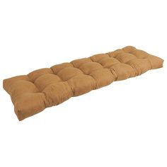 a brown cushion that is on top of a white wall