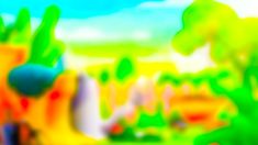 the blurry image shows green and yellow plants in front of a blue sky with white clouds