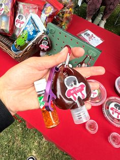 a hand holding a bottle with some candy on it