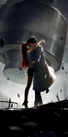 a man and woman kissing in front of a giant object