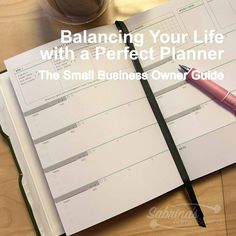 a notebook and pen sitting on top of a desk next to a cup of coffee