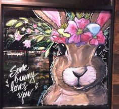 a painting of a bunny with flowers on its head and the words some bunny loves you