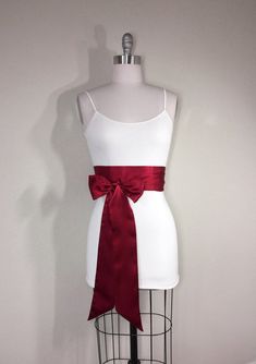 "Cranberry Red Sash Deep Red Satin Sash Reversible Double Waist Wrap Belt Dark Red Obi Sash Belt Bridal Sash Wedding Sash Satin Swank Make this Satin Swank® reversible waist sash the perfect finishing touch for your wedding, bridesmaid, or special occasion dress, or just the right piece to add instant polish to your dress or top. This extra long version is 3.5 inches wide, 120 inches long, and will wrap around most waist sizes two times with a generous length remaining to tie in a bow or a simpl Elegant Red Wedding Sash, Satin Sashes With Ribbon For Gift, Elegant Red Sash For Party, Elegant Red Party Sash, Bridesmaid Belt, Obi Sash, Wedding Dress Sash, Wedding Sash Belt, Waist Sash