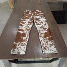 the cow print leggings are on top of a table