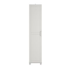 a tall white cabinet sitting on top of a white floor next to a wall mounted toilet