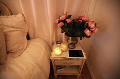 a small table with flowers and candles on it