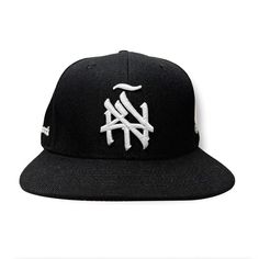 Introducing our New York (ÑY) Hometown Logo Snapback Hat – featuring our remixed 3d embroidered logo with a tilde design on the front, under brim is gray, the right side features our Nueva York "Split Logo" design and the left side highlights a "Latinos Unidos" emblem with flags from Colombia, Puerto Rico, Dominican Republic and Mexico. Our “NY Hometown Logo” intertwines the "N" and "Y," inspired by the Yankees and Mets interlocking insignias; merging classic sports heritage with a handmade, sty Hip Hop Black Fitted Hat With Embroidered Logo, Black Hip Hop Fitted Hat For Streetwear, Streetwear Hat With Curved Brim, Black Flat Brim Fitted Hat For Streetwear, Gray Baseball Cap With Embroidered Logo For Streetwear, Gray Snapback Fitted Hat For Streetwear, Adjustable Hats With Letter Print For Streetwear, Adjustable Streetwear Hat With Letter Print, Urban Hat With Curved Brim And Adjustable Fit