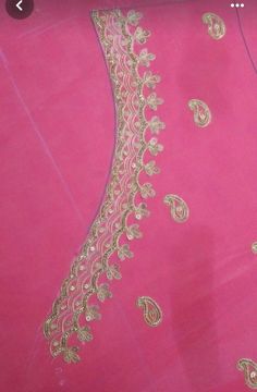 a pink dress with gold lace on it