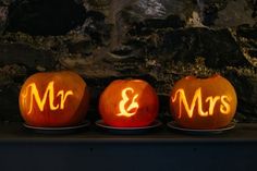 three carved pumpkins with the names mr and mrs on them