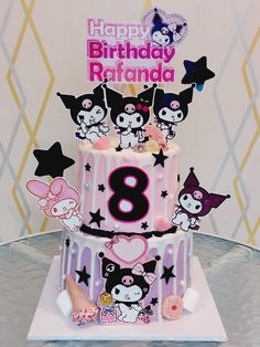 a birthday cake is decorated with cartoon characters and stars on the bottom tier, along with an eight candle