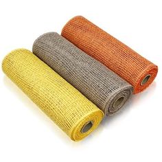 three rolls of orange, yellow and grey burlocked fabric on white background